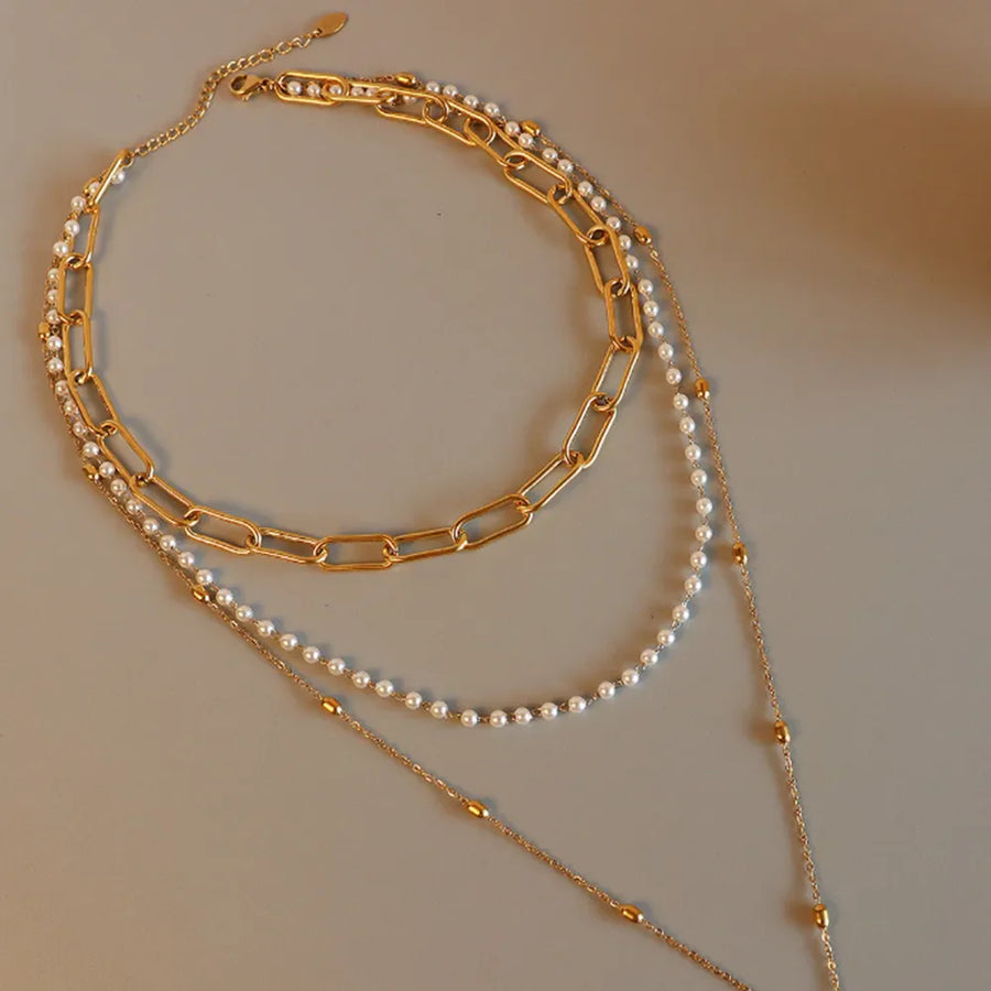 Gold layered necklace with chunky chain, pearls, and bead accents