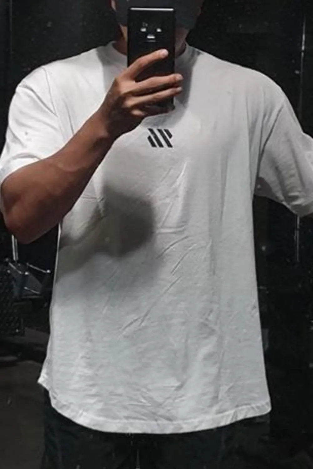 White oversized t-shirt with black logo detail on chest