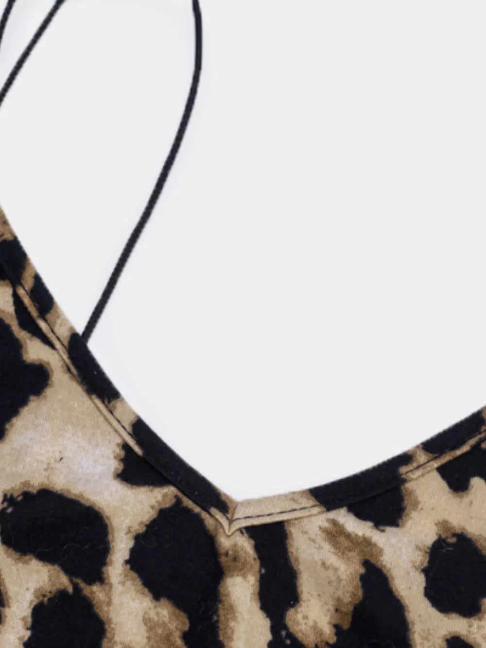 Leopard print midi dress with spaghetti straps and deep v-neck.