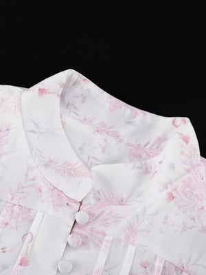 White floral print blouse with a collared neckline and button front.