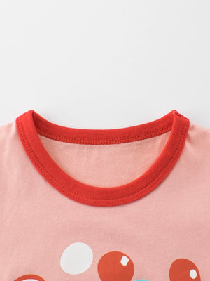 Pink t-shirt with red trim neckline and polka dot pattern.