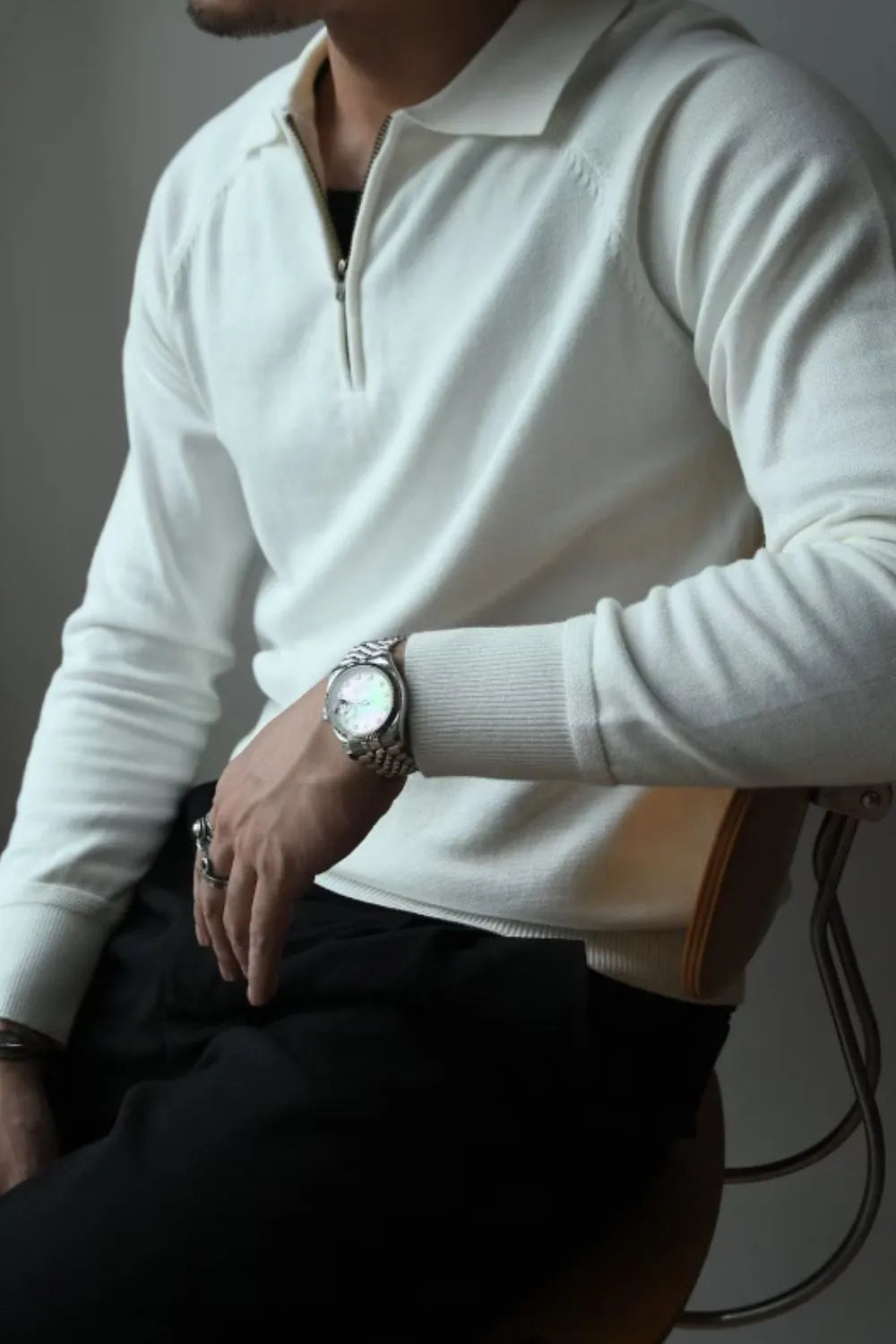Ivory knit polo with zip-through neckline and raglan sleeves.
