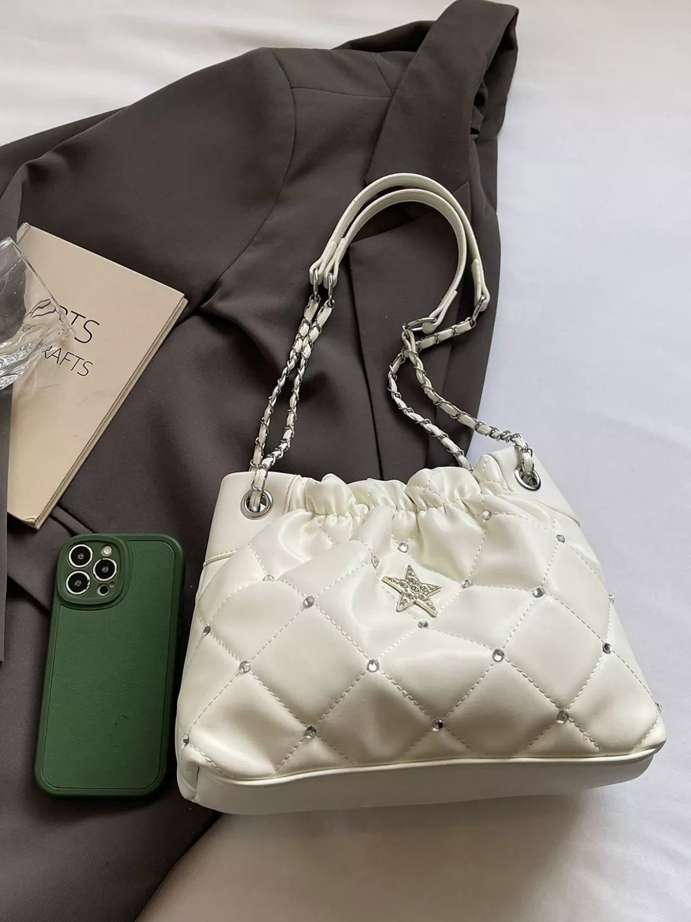 White quilted shoulder bag with rhinestone star detail and chain strap