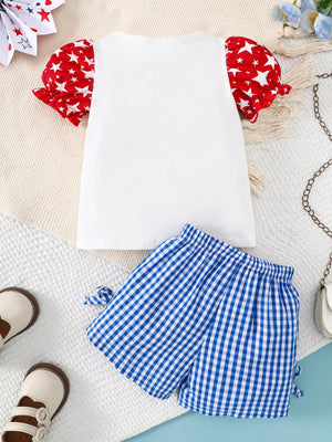 Baby girl's white tee with red star print puff sleeves and blue gingham bow shorts.