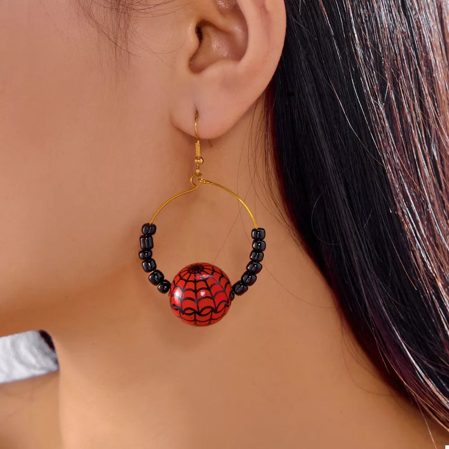 black earrings featuring gold-plated and spiderweb