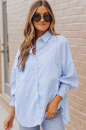Pastel blue pinstripe blouse with balloon sleeves and a collared neckline.