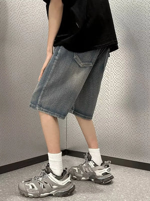 Men's vintage wash stretch denim shorts in medium blue, casual fit, mid-thigh length.
