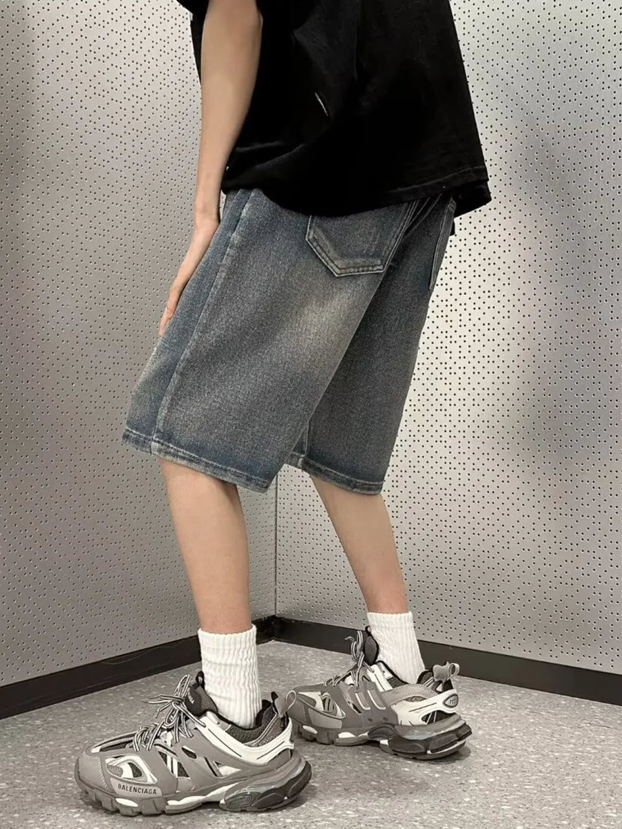 Men's vintage wash stretch denim shorts in medium blue, casual fit, mid-thigh length.