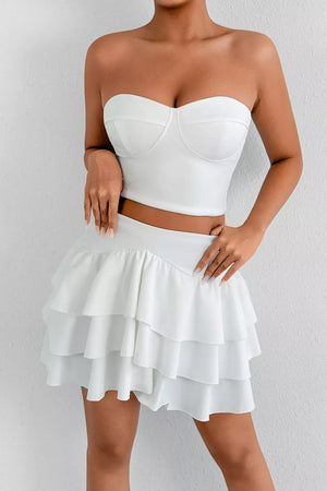 White strapless sweetheart bustier crop top and tiered ruffle mini skirt set
