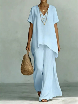 Light blue linen blend v-neck short sleeve tunic and wide leg pants set with layered necklaces.