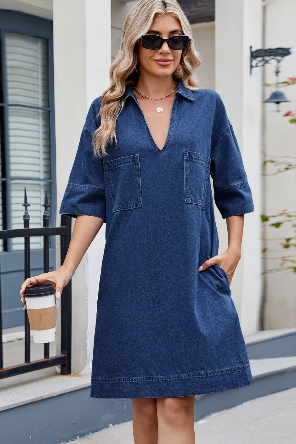 Dark denim collared mini dress with V-neck, short sleeves, and two chest pockets.