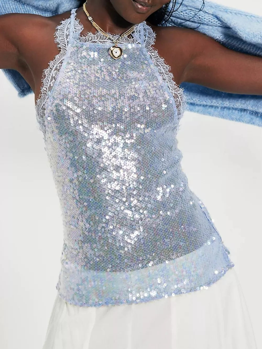 Blue sequin halter cami with lace trim and a heart pendant necklace.