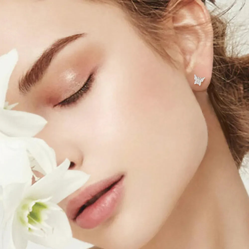 Moissanite butterfly stud earrings in silver with sparkling details.