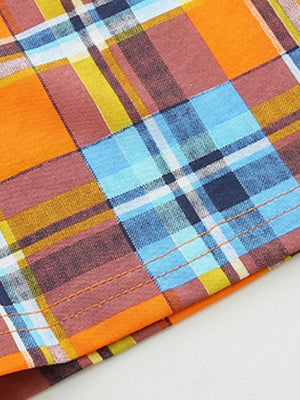 Baby plaid shorts in orange, blue, and brown cotton with contrast stitching.