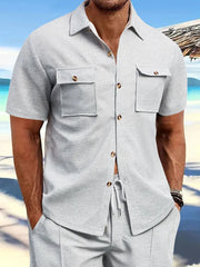 Gray textured resort shirt with short sleeves, button front, and two patch pockets.