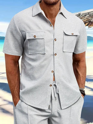 Gray textured resort shirt with short sleeves, button front, and two patch pockets.