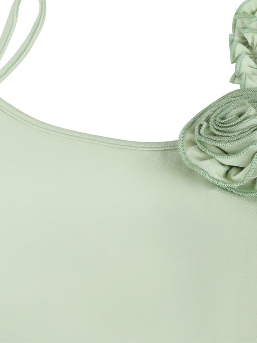 Light green ruffled mermaid maxi dress with a floral detail on the strap.