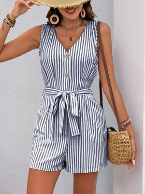 Button-front striped romper with V-neck, sleeveless, waist tie, and short legs in blue and white stripe.