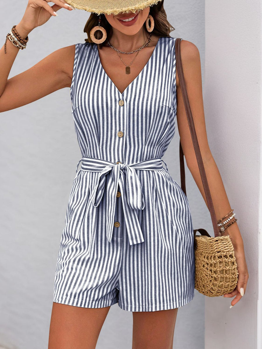 Button-front striped romper with V-neck, sleeveless, waist tie, and short legs in blue and white stripe.