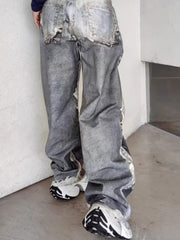 Men's grey wide-leg jeans with heavy distressing and rips.