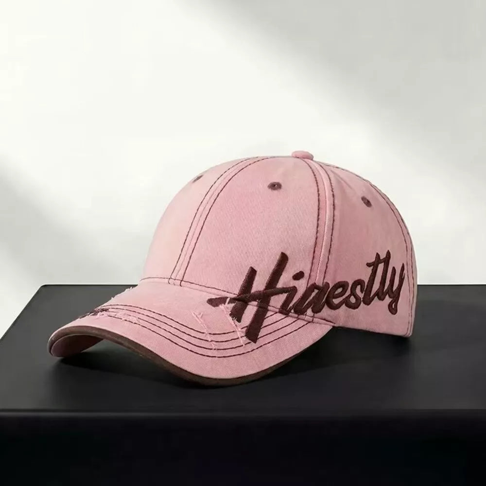 Pink cotton baseball cap with brown embroidery and distressed details