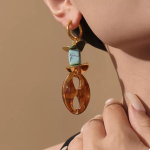 earrings in turquoise featuring geometric shapes and drop fit