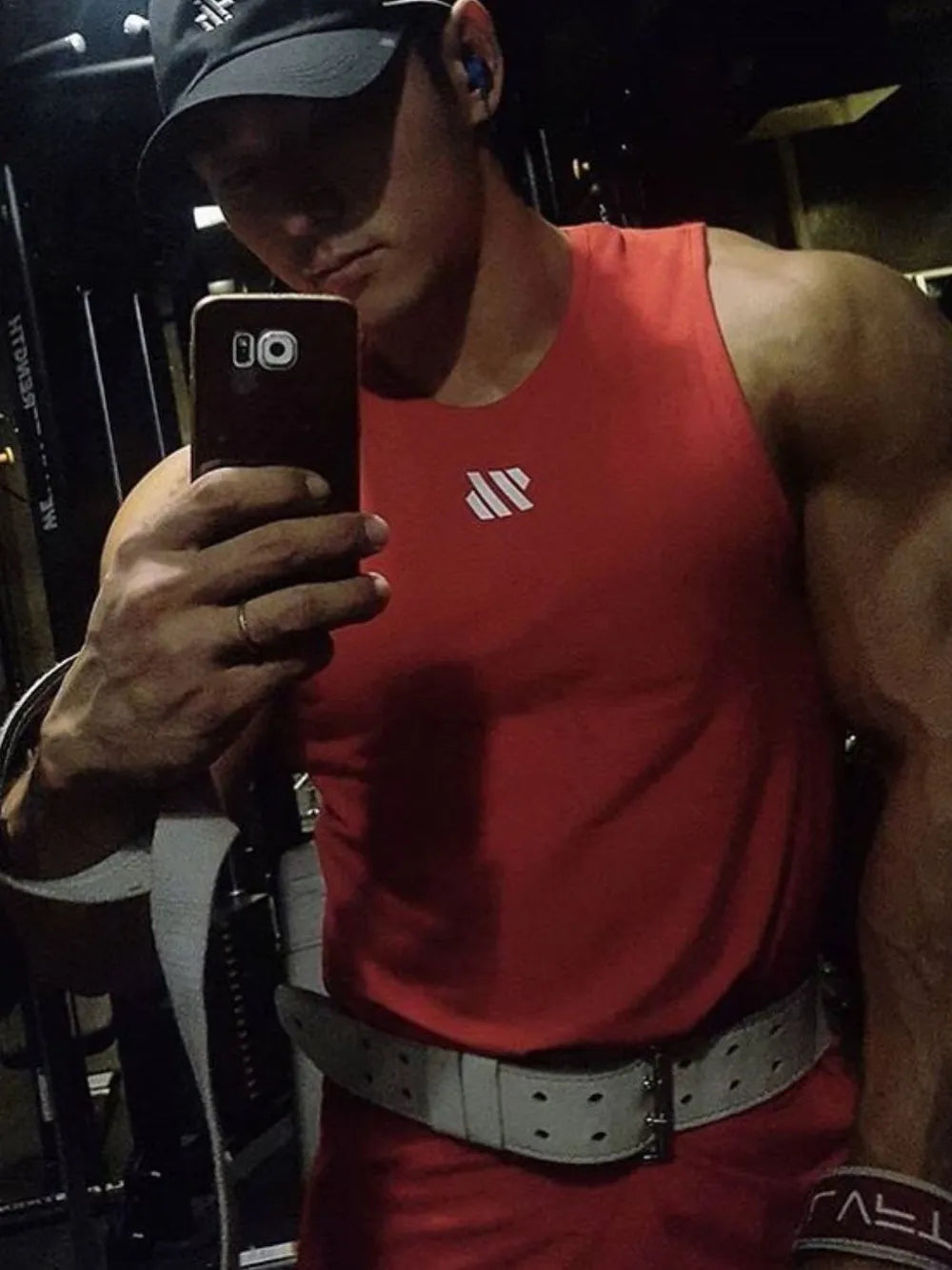 Deep red performance tank top with minimalist white logo, crew neck, sleeveless.