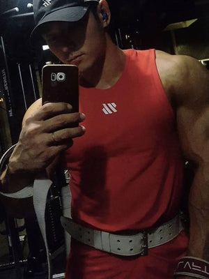 Deep red performance tank top with minimalist white logo, crew neck, sleeveless.