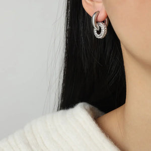 Silver pavé circle interlock earrings with a polished finish.