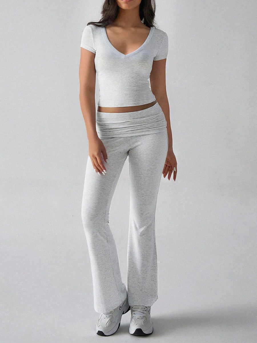Light gray ribbed flare leg lounge set with v-neck crop top and ruched waistband pants.