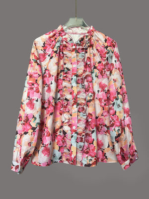 Frill trim button-up shirt with a vibrant floral print and ruffled placket.