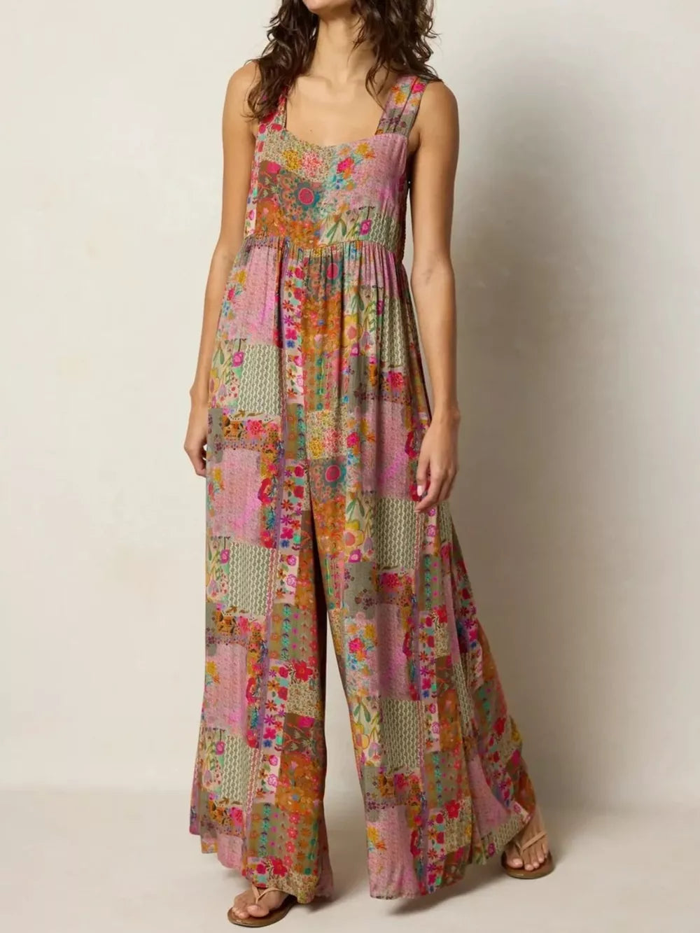 Vibrant patchwork wide-leg romper with a square neckline and wide straps.