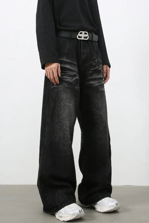 Faded black palazzo jeans in distressed denim with a wide leg and high waist.