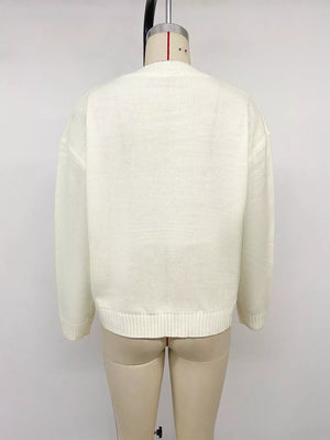 Cream knit sweater with crew neck and ribbed hem and cuffs