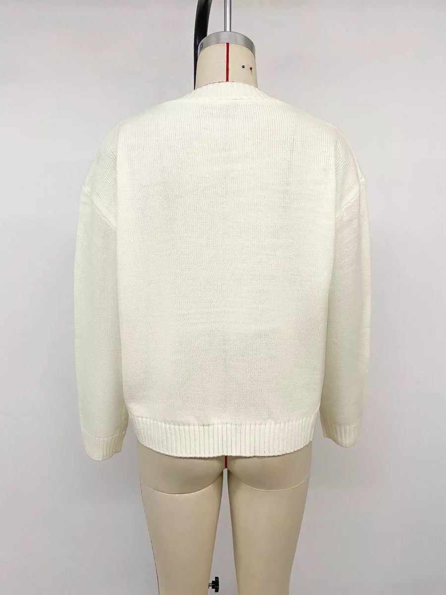 Cream knit sweater with crew neck and ribbed hem and cuffs