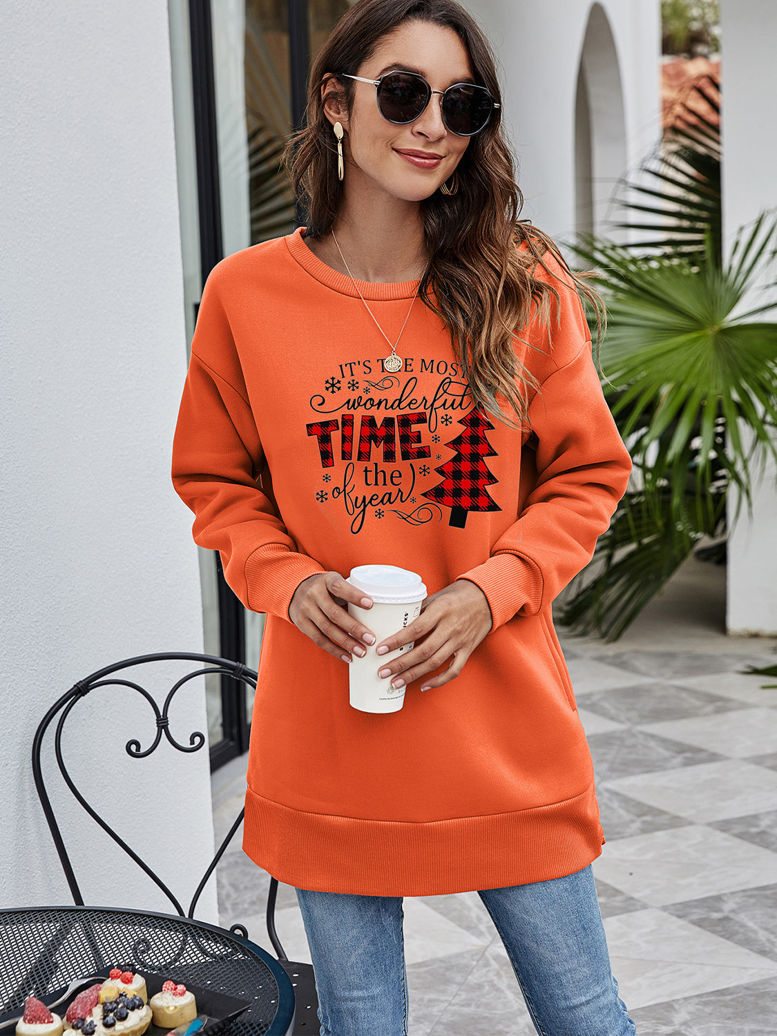Orange tunic sweatshirt with holiday graphic and plaid Christmas tree detail.