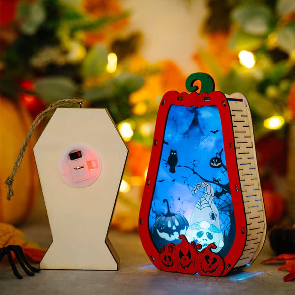 Spooky Silhouette Lantern Trio ornaments, one coffin, one pumpkin with Halloween scene, battery-operated.