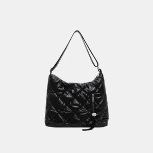 Black diamond quilt padded shoulder bag with a zippered pocket and tassel detail.