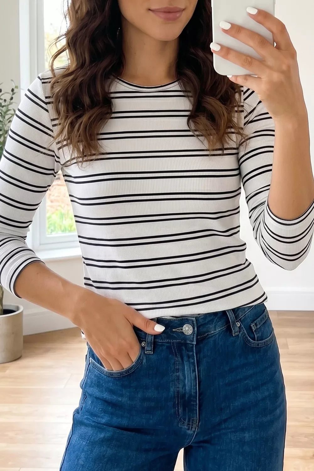 Ribbed white long sleeve top with black horizontal stripes and crew neck.