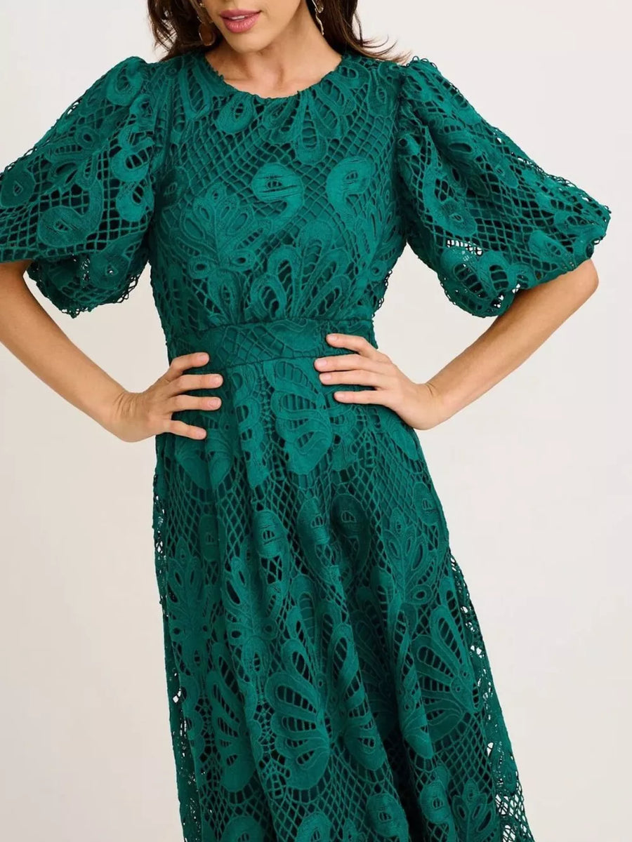Green lace midi dress with puff sleeves and intricate cutout pattern.