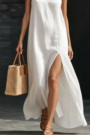 White V-neck maxi dress with a high slit, sleeveless, breezy casual style.