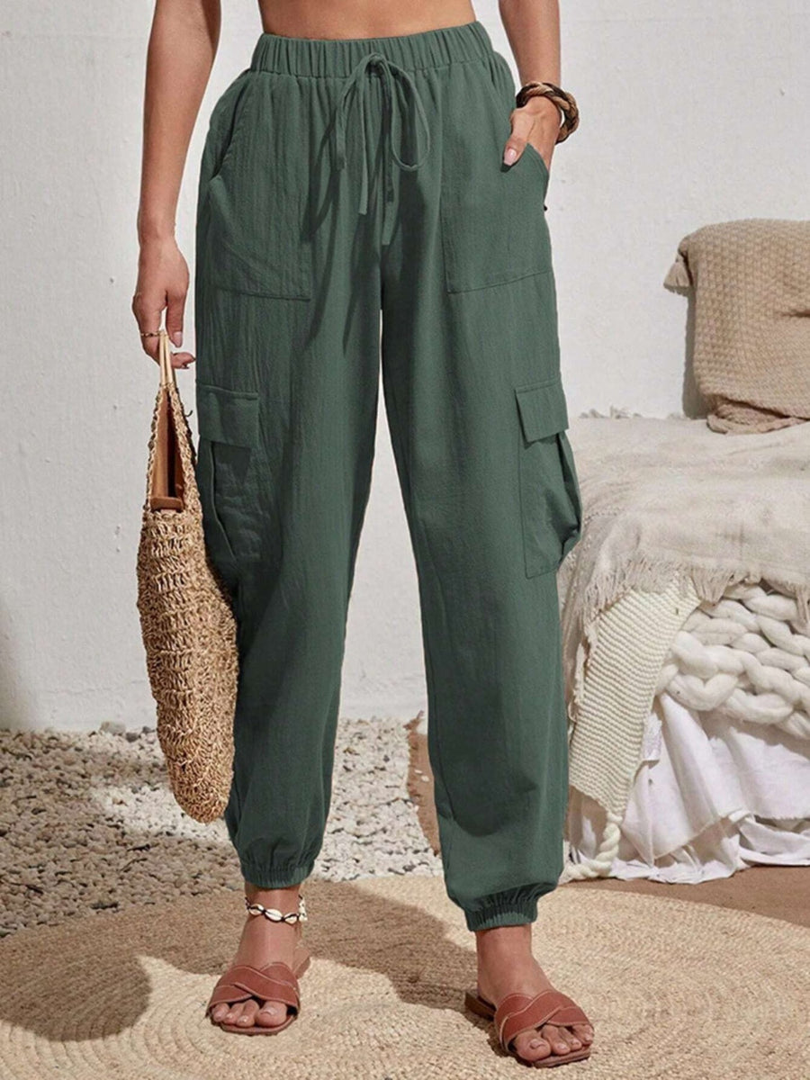 Textured cargo lounge trousers in dark green with drawstring waist and elastic cuffs.