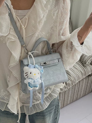 Pastel blue croc-embossed mini crossbody bag with Hello Kitty charm