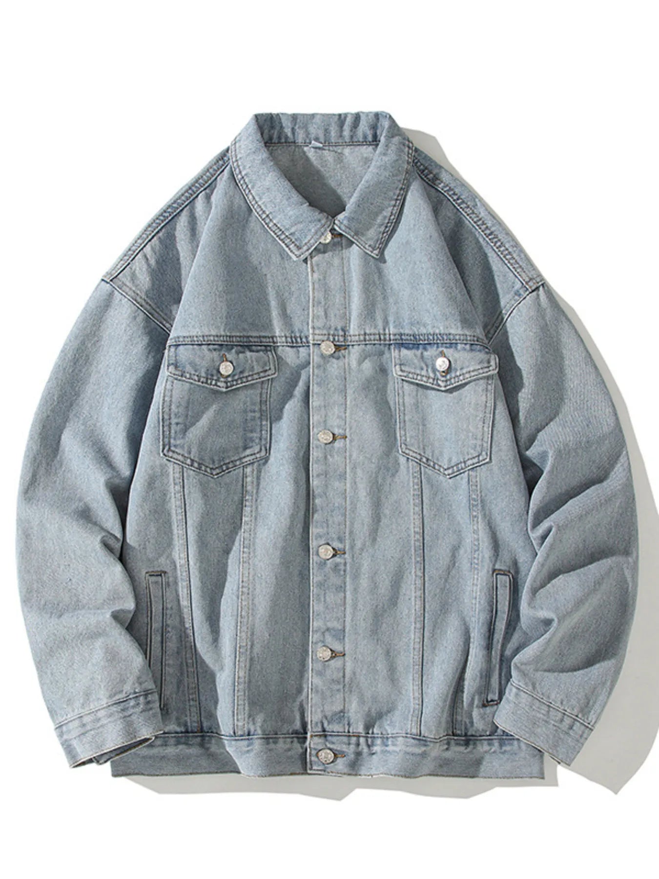 Light blue 100% cotton denim trucker jacket with button-up front and chest pockets.