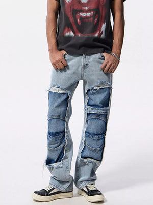 Men's light wash cotton jeans with distressed patchwork and ripped details.