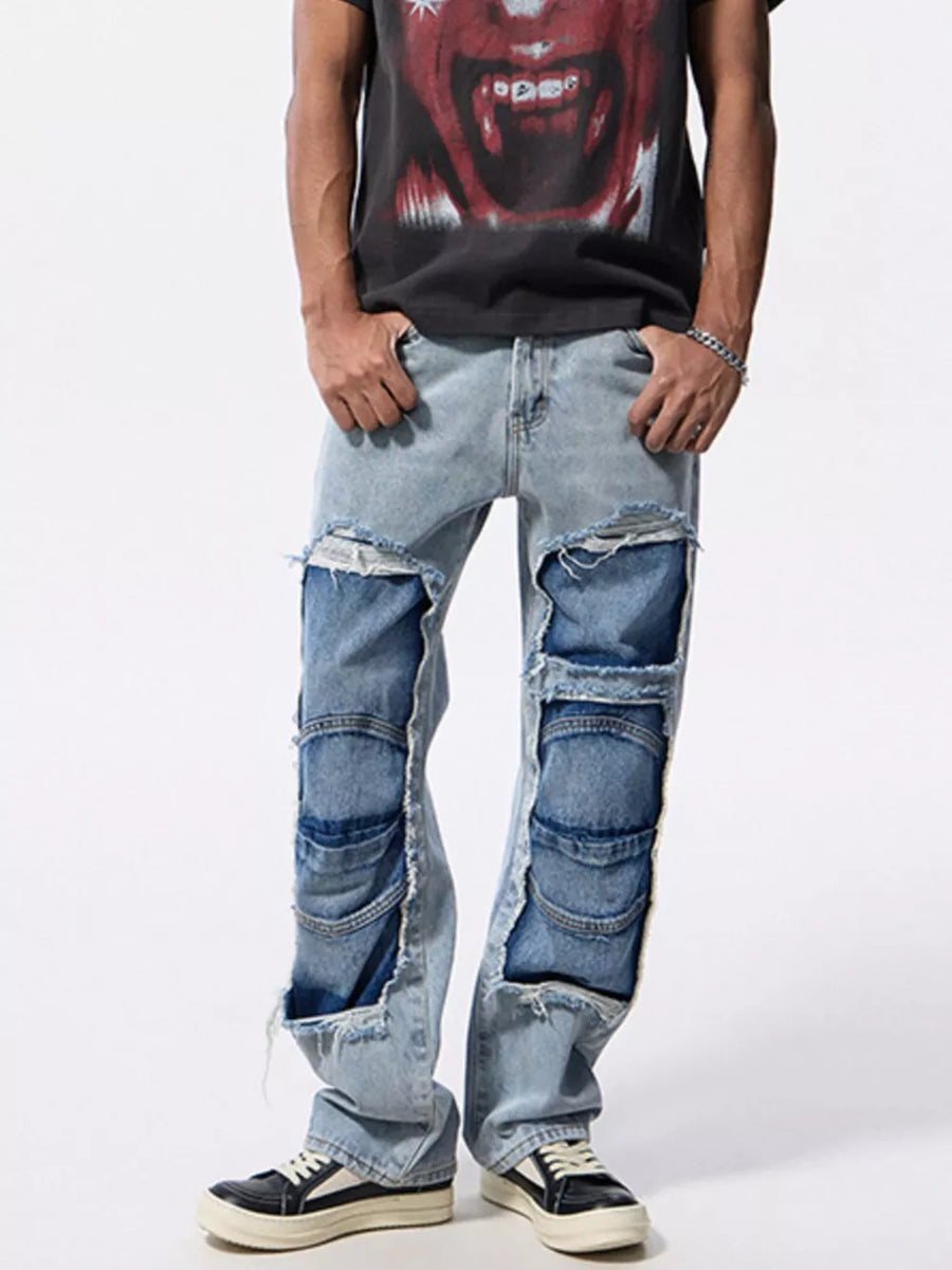 Men's light wash cotton jeans with distressed patchwork and ripped details.