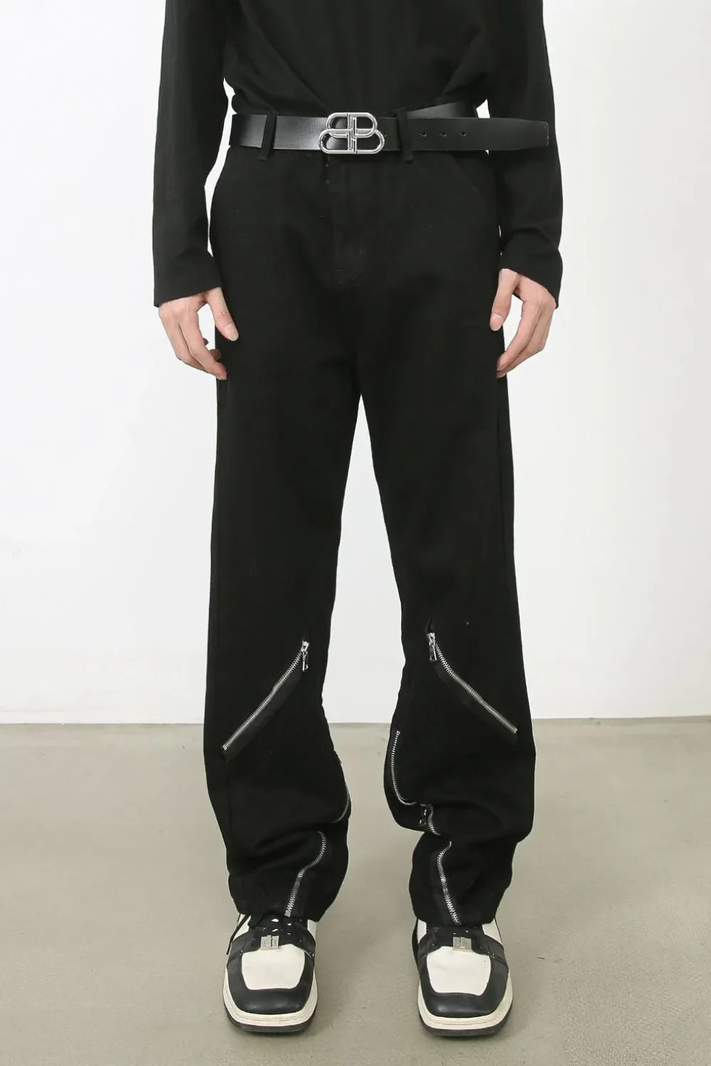 Zipped hem black denim trousers with a casual, chic style.