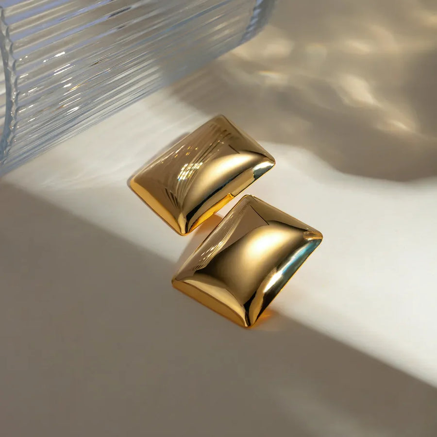 Sculpted gold rectangle earrings with a polished finish.
