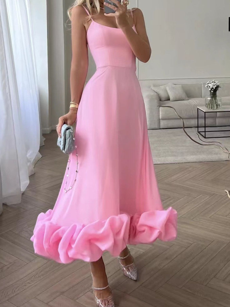 Pink midi dress with spaghetti straps and a dramatic ruffle hem.