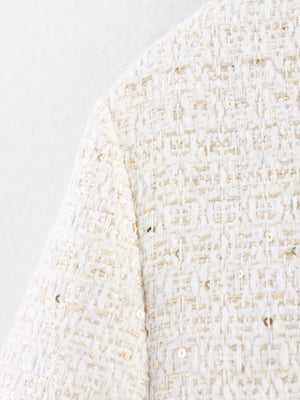 White tweed cropped jacket with gold sequins and button-up detail.